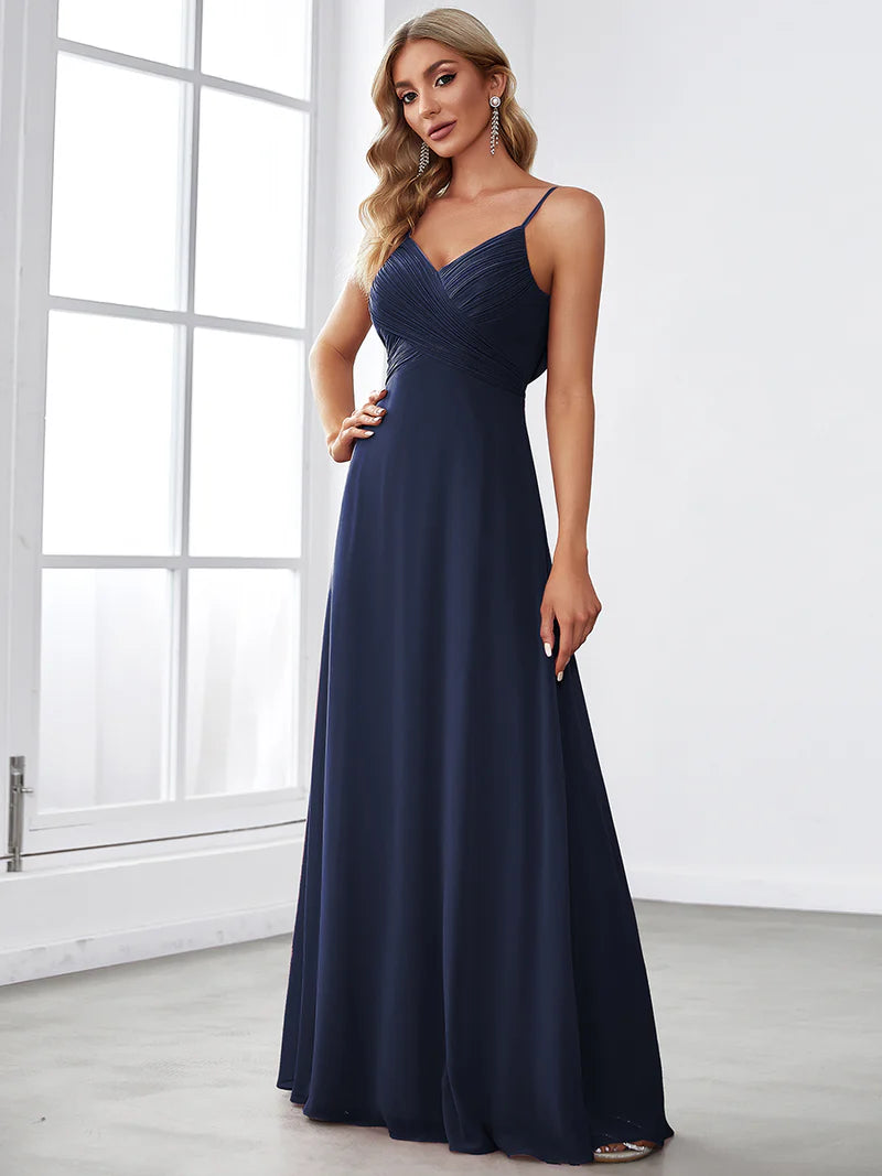 Sleeveless navy blue bridesmaid dress with spaghetti straps.