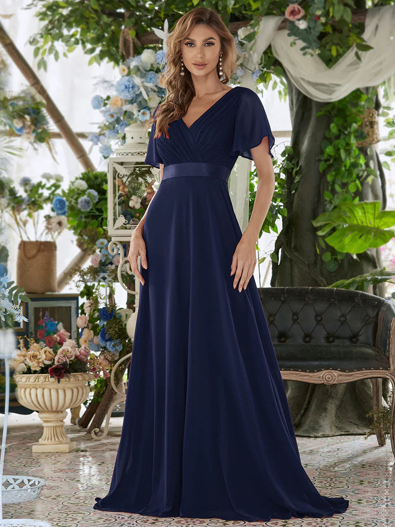 Navy blue formal dress in chiffon with satin band and short sleeves.