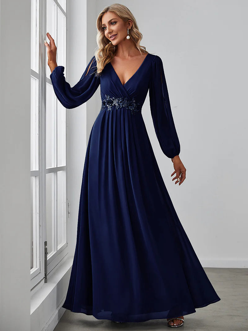 Navy blue long sleeve formal dress with applique detail.