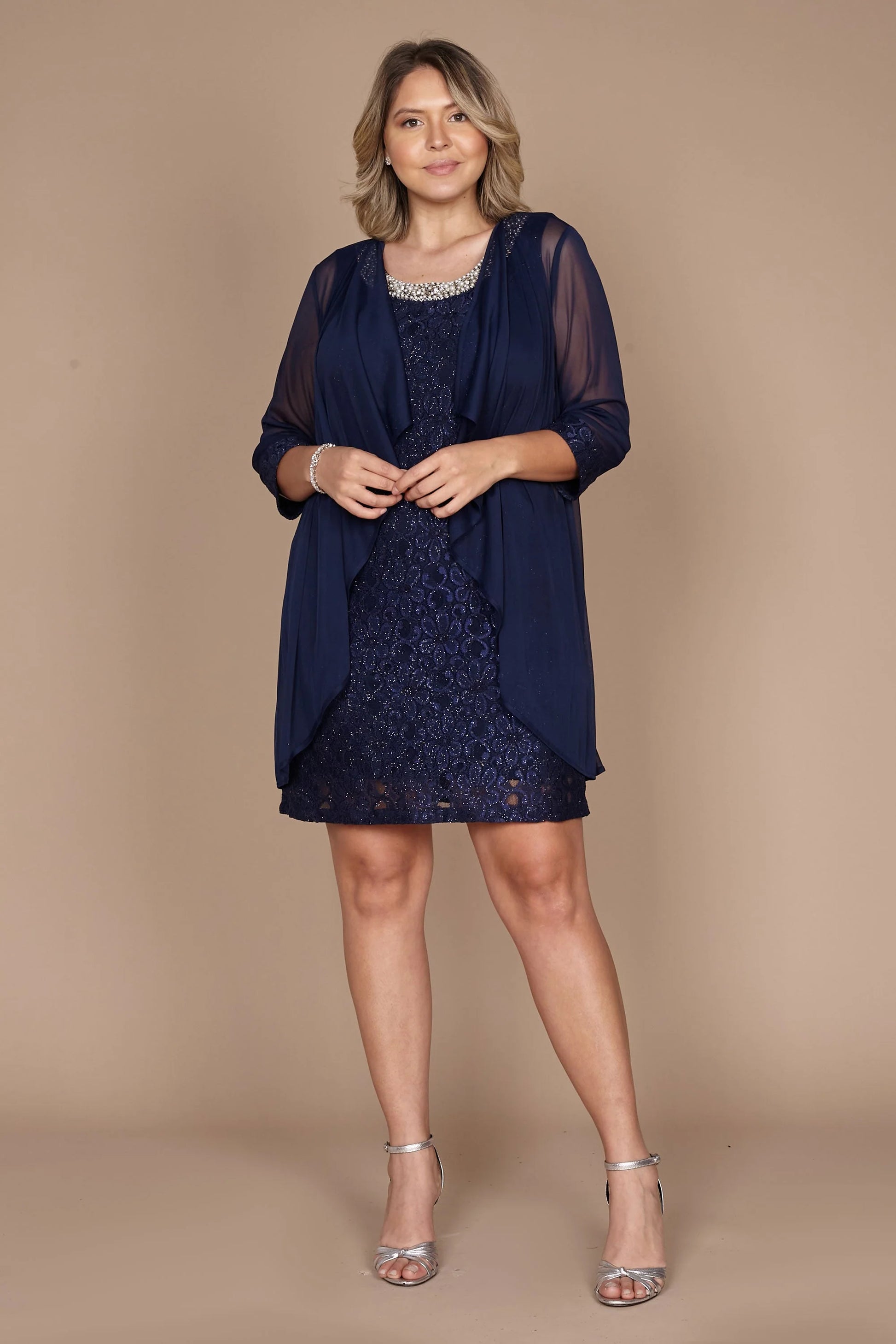 Navy blue Short length short sleeve Mother of the bride dress with pearl beading detail and chiffon jacket.