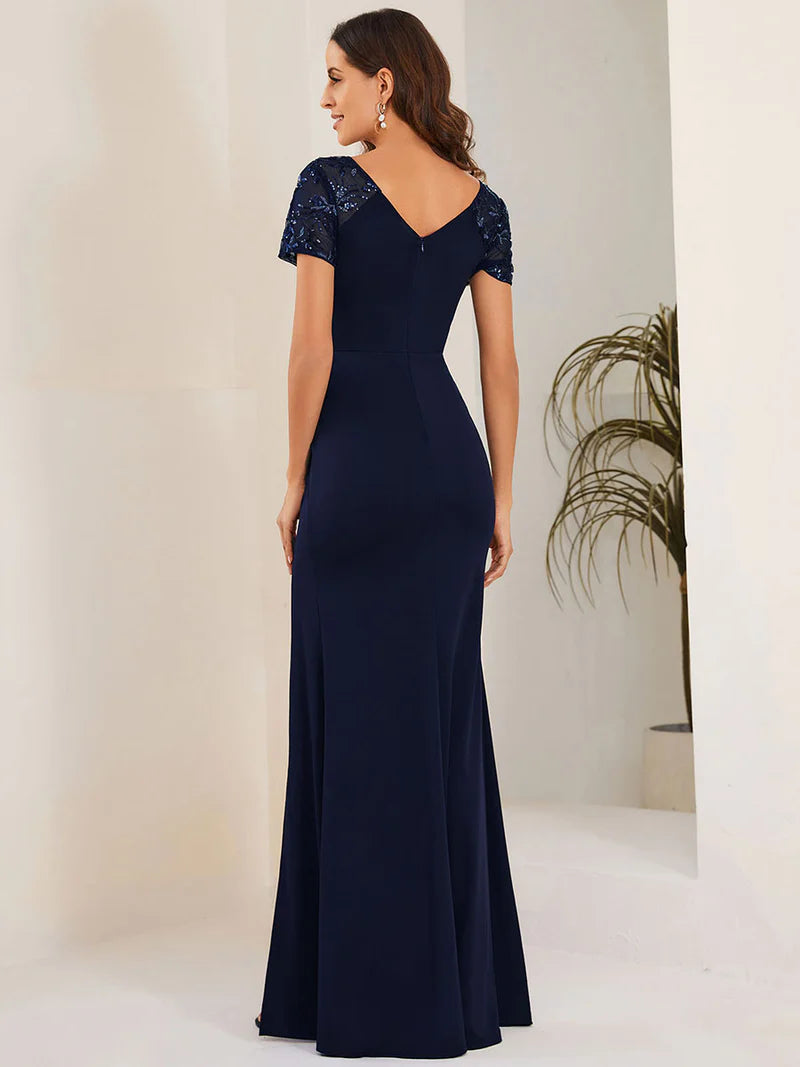 An elegant mother of the bride long navy blue applique cap sleeved formal or evening dress, ruched at the middle.