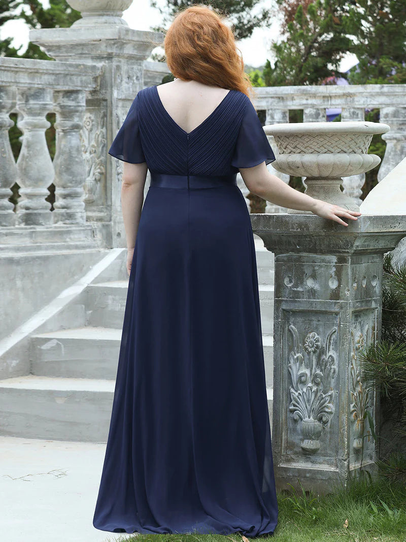 Navy blue plus size bridesmaid dress or formal dress in chiffon with short sleeves and a satin band.
