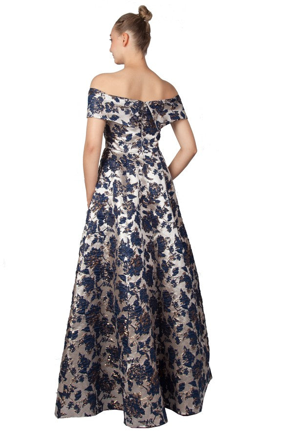 Navy blue and silver formal dress with off shoulder design in a brocade fabric.