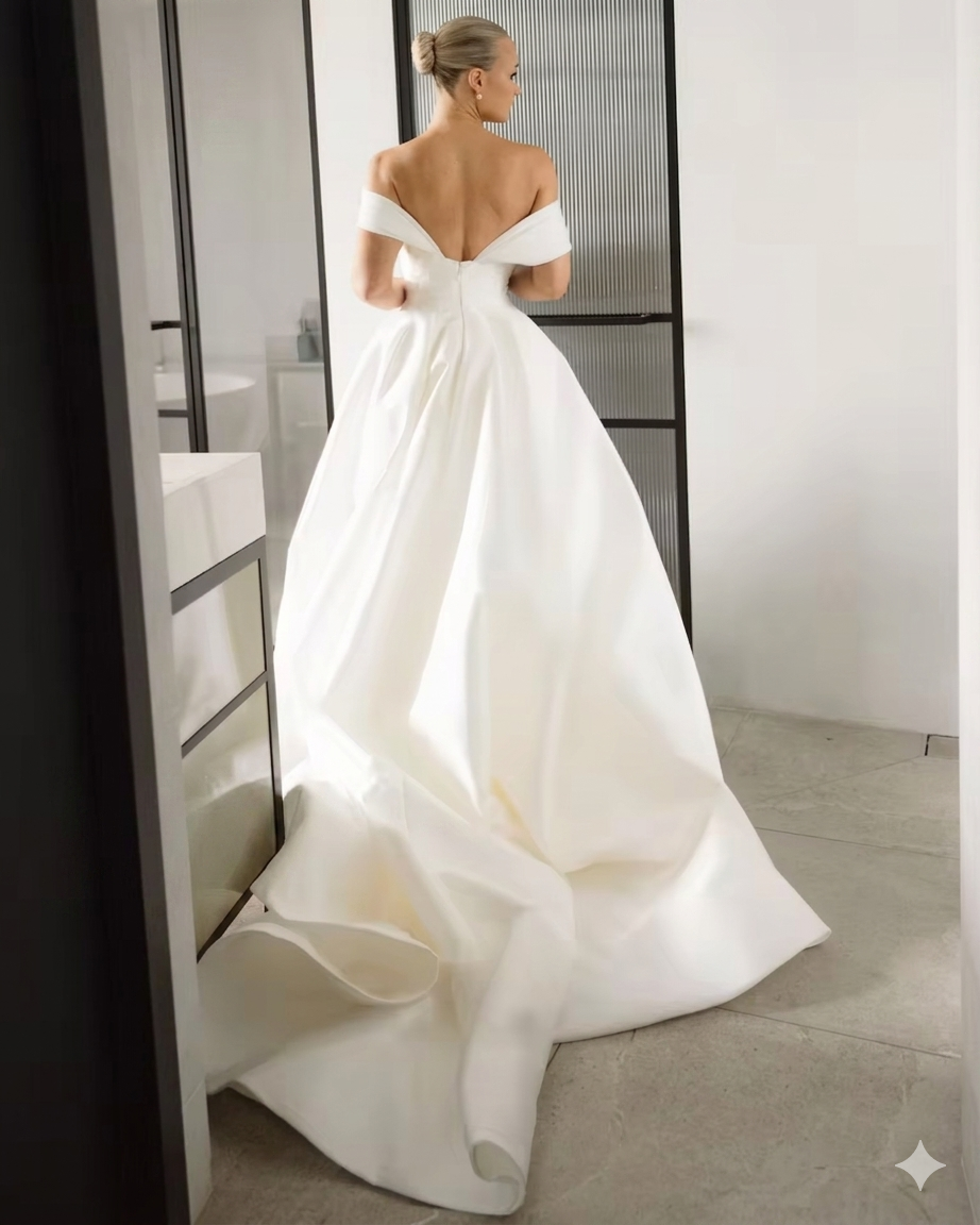 Off shoulder ivory a-line wedding dress with train.