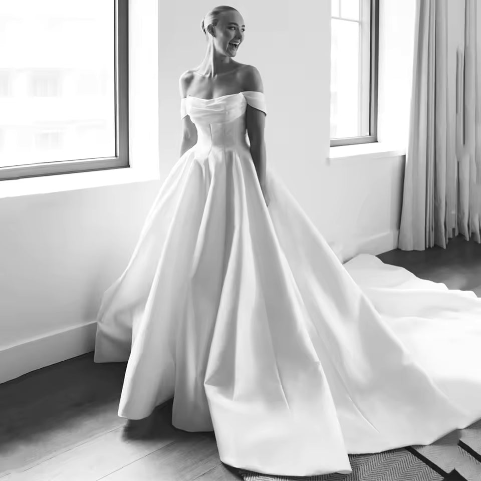 Off shoulder ivory a-line wedding dress with train.