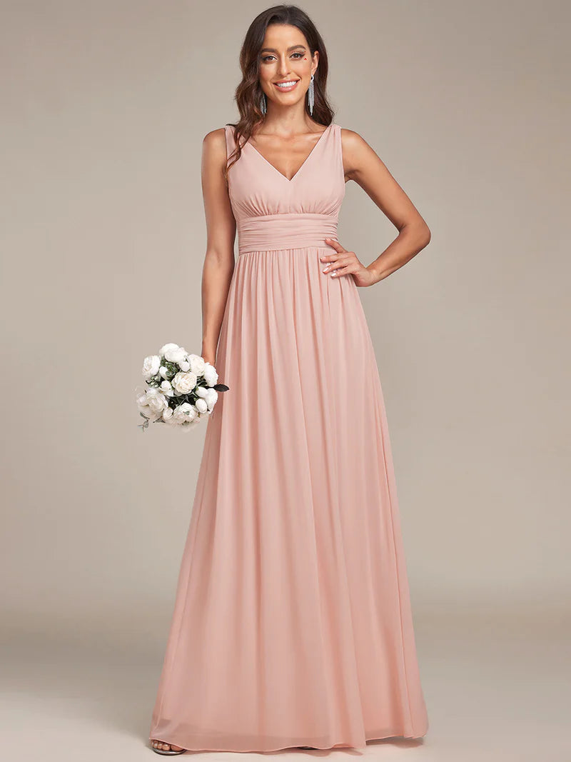 Pink bridesmaid dress with double v-neck and chiffon.