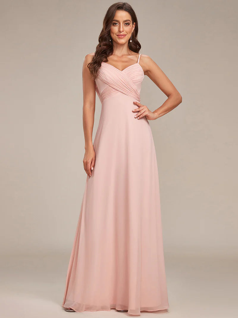 Sleeveless pink bridesmaid dress with spaghetti straps.