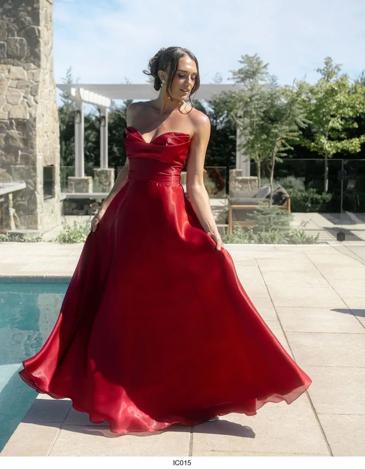 Red satin and organza strapless formal dress with button detail down the back.