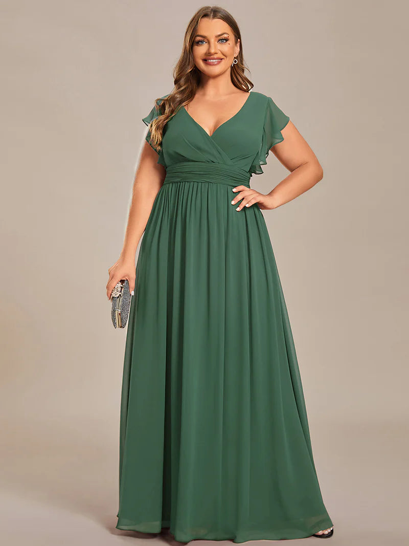 Sage green plus size bridesmaid dress with ruffle sleeve and open back detail.