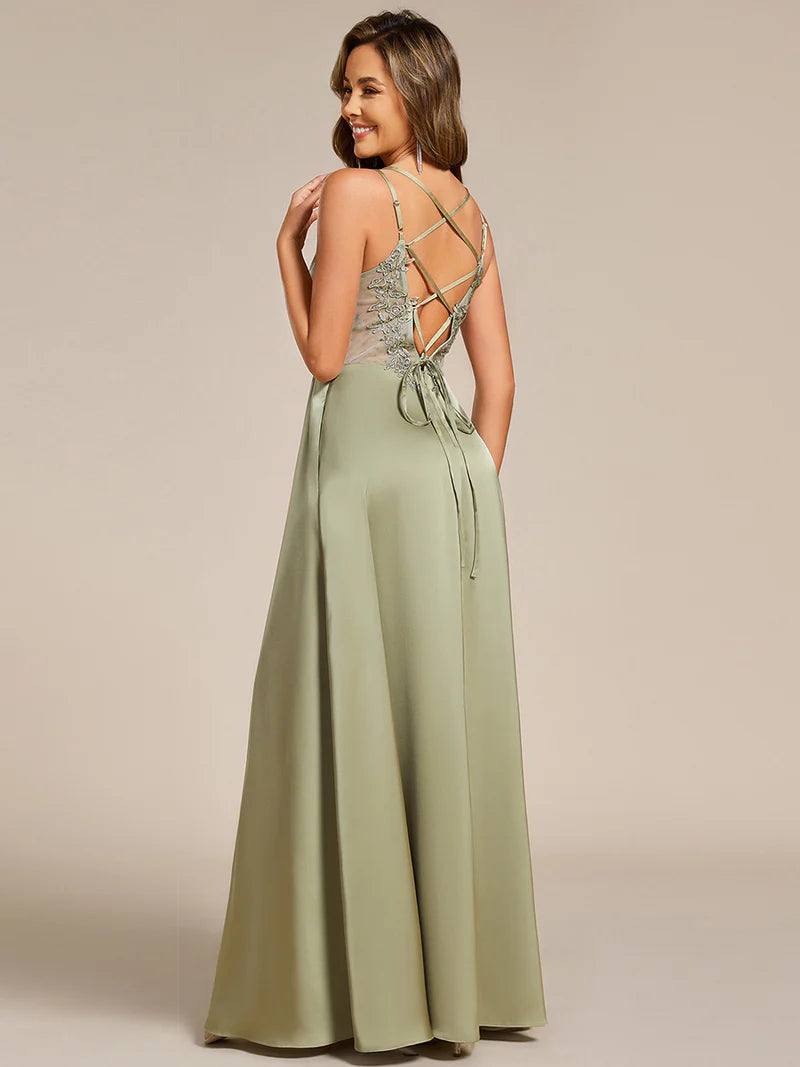 Sage green satin bridesmaid dress in A-line style with spaghetti straps and lace up back detail.