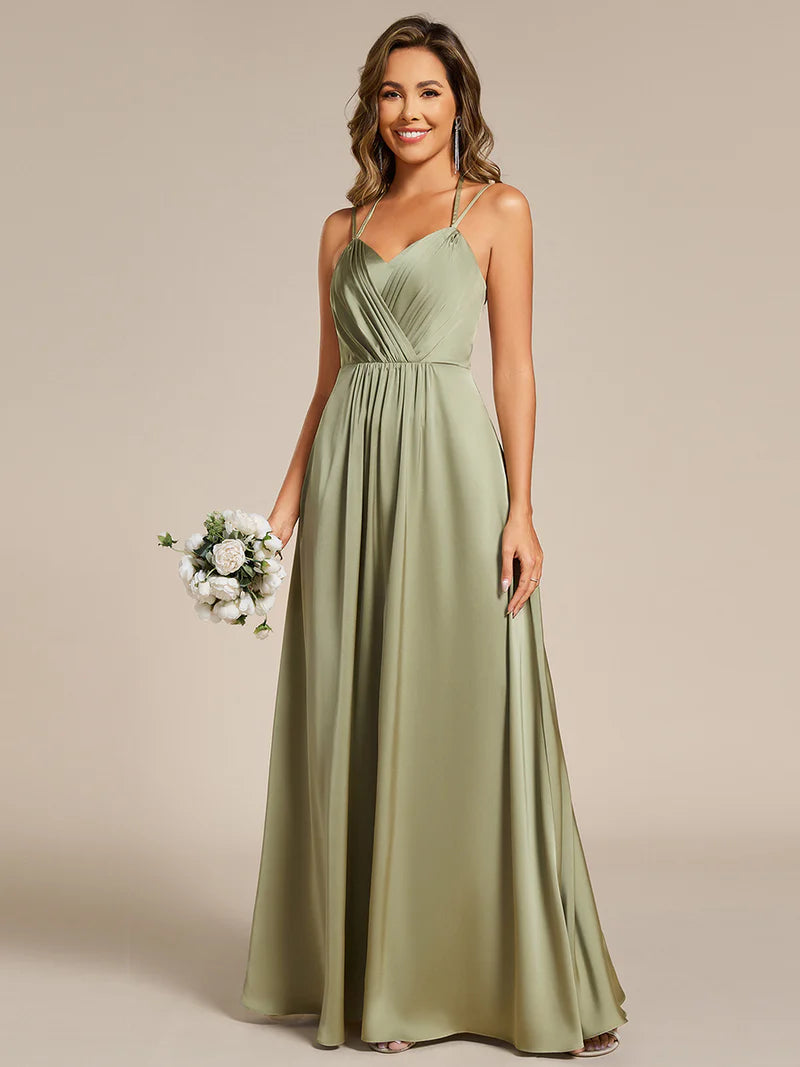 Sage green satin bridesmaid dress in A-line style with spaghetti straps and lace up back detail.