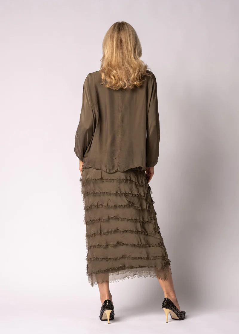 Silk green mother of the the bride dress with frayed edge skirt and ruched top.