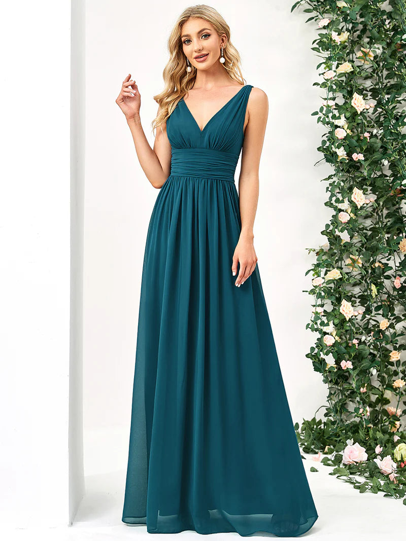 Teal bridesmaid dress with double v-neck and chiffon.