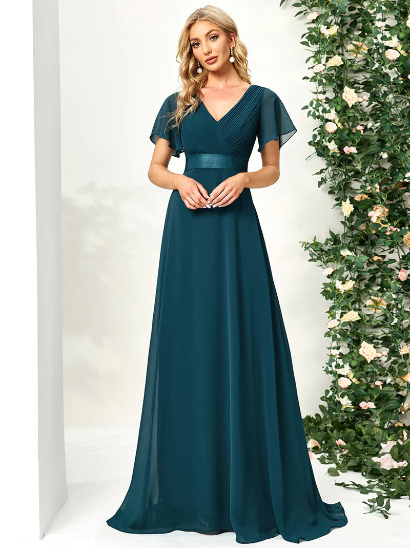 Teal formal dress in chiffon with satin band and short sleeves.
