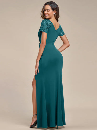 An elegant mother of the bride long teal applique cap sleeved formal or evening dress, ruched at the middle.