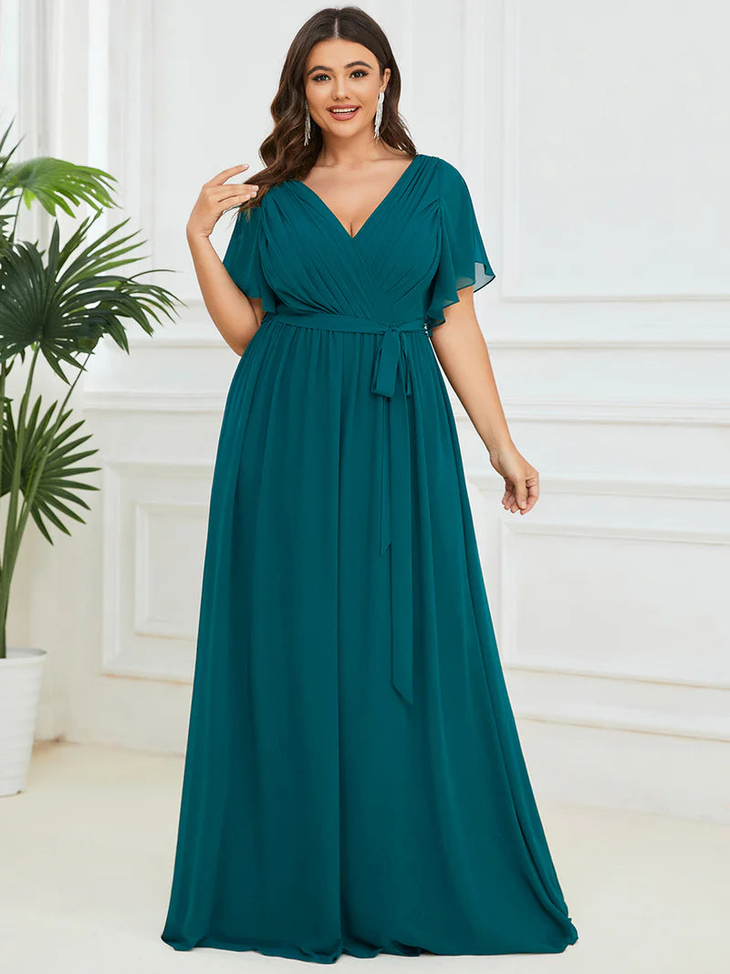 Teal plus sized bridesmaid dress with v-neck and a-line.