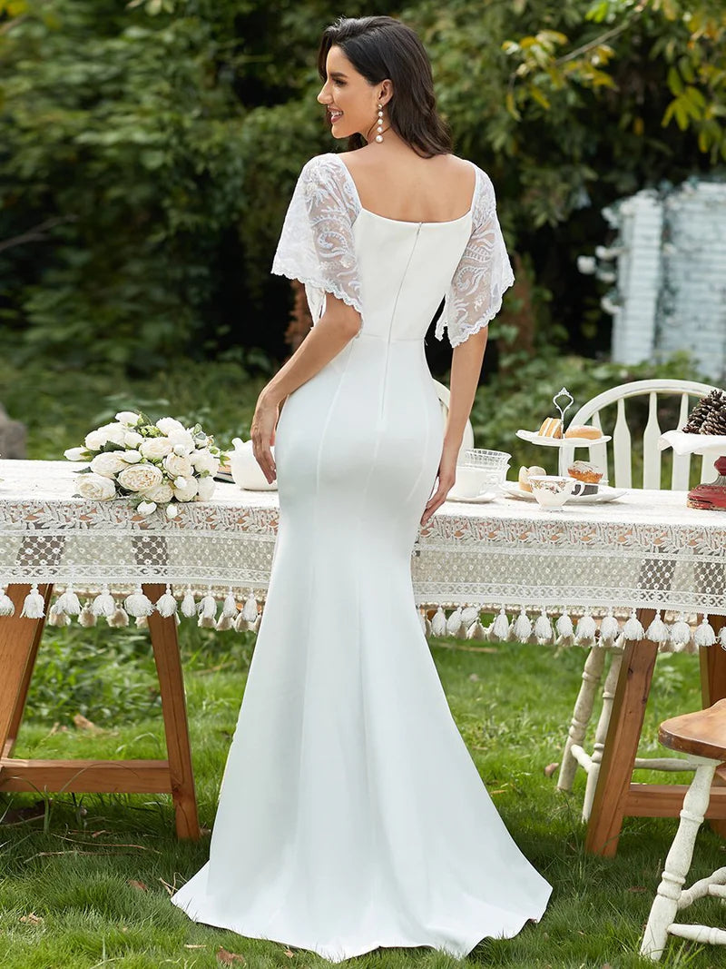 White formal or wedding dress with lace sleeves, v-neck and fishtail.