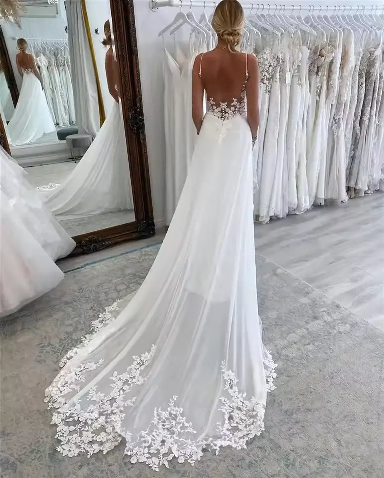 White plus size chiffon wedding dress with spaghetti strap and lace bodice.