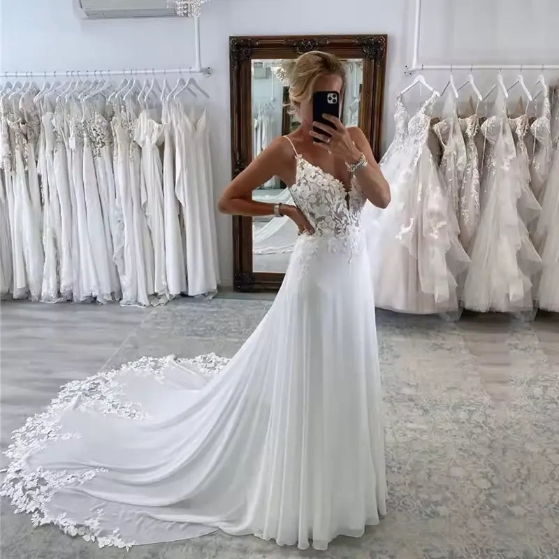 White plus size chiffon wedding dress with spaghetti strap and lace bodice.