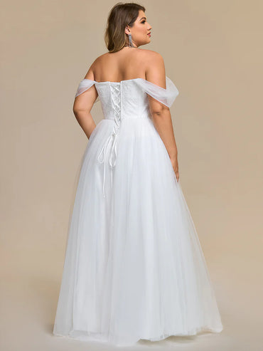 White Plus Size wedding dress with off the shoulder straps and lace up back.
