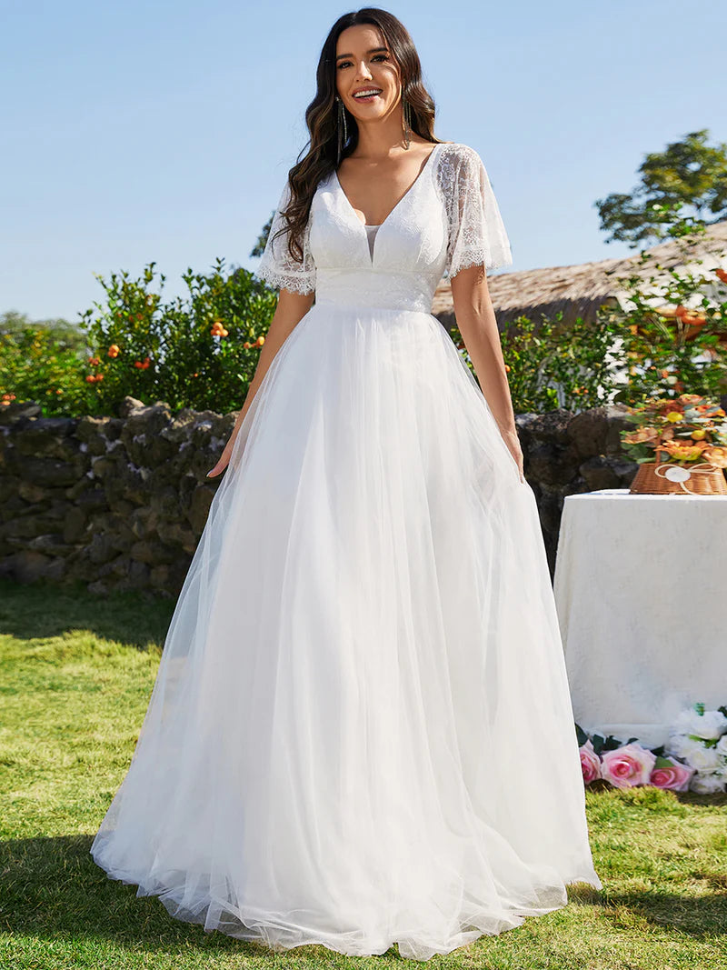 White Plus Size Wedding Dress with short lace sleeve and tulle skirt.
