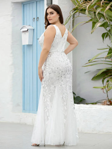White plus sized wedding dress with fishtail and sequins.