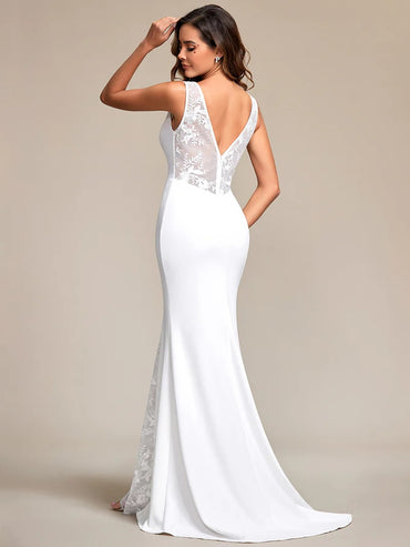 White wedding dress with spaghetti strap, fishtail and v-neck.