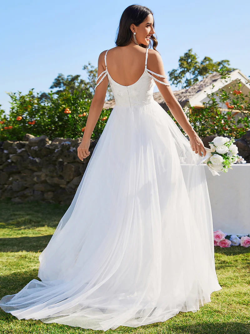 White wedding dress with pearl straps and tulle skirt.