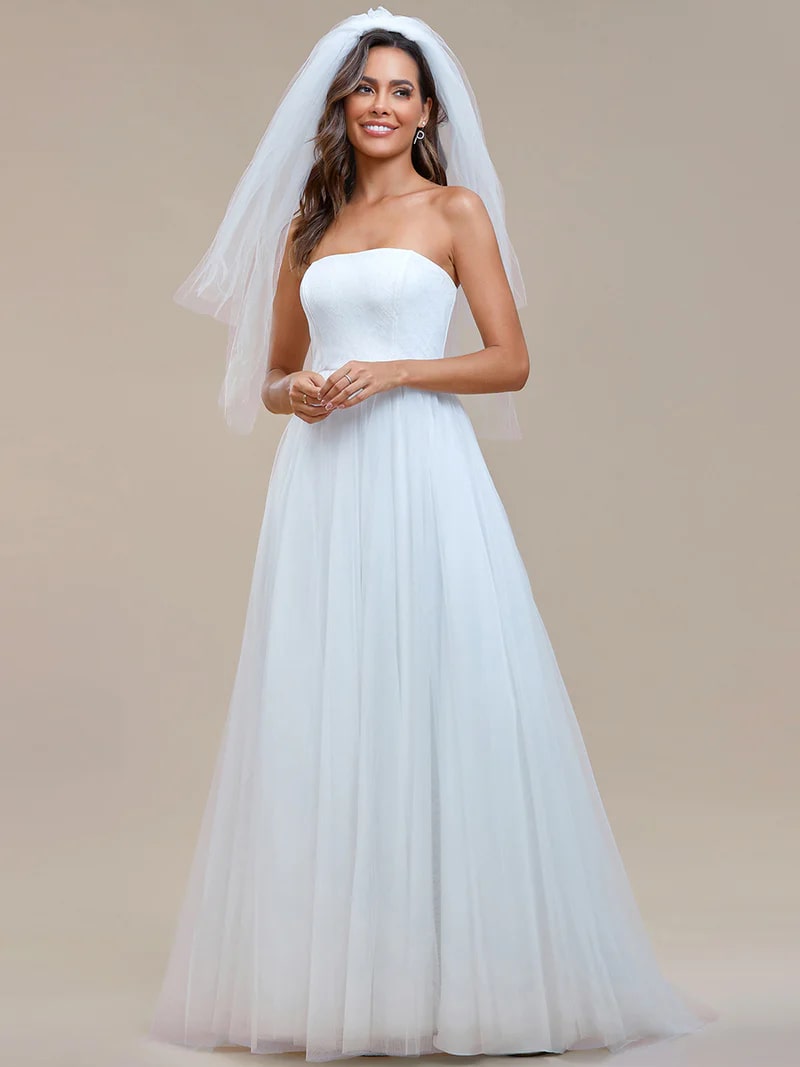 White wedding strapless dress with tulle skirt, lace top and lace up back.