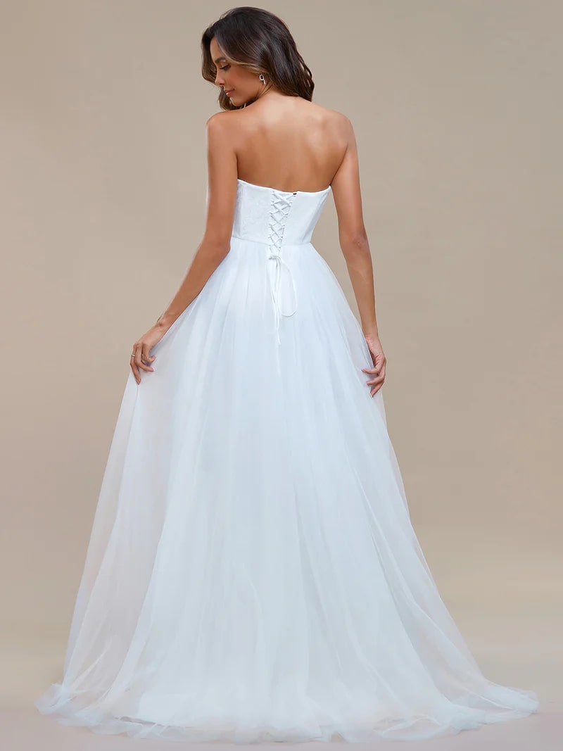 White wedding strapless dress with tulle skirt, lace top and lace up back.