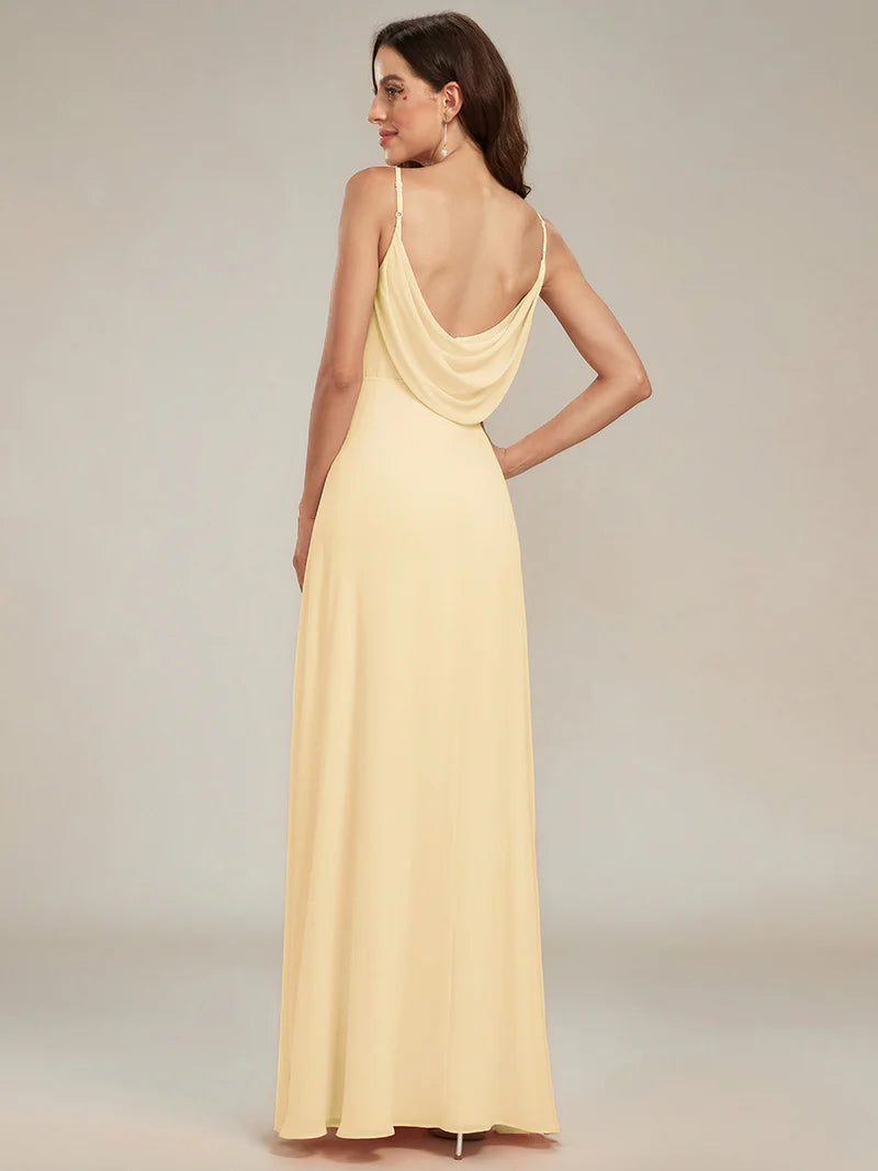 Sleeveless yellow bridesmaid dress with spaghetti straps.