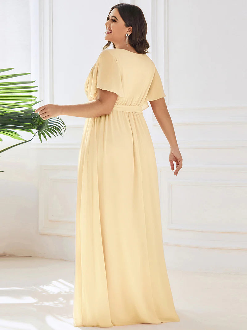 Yellow plus sized bridesmaid dress with v-neck and a-line.