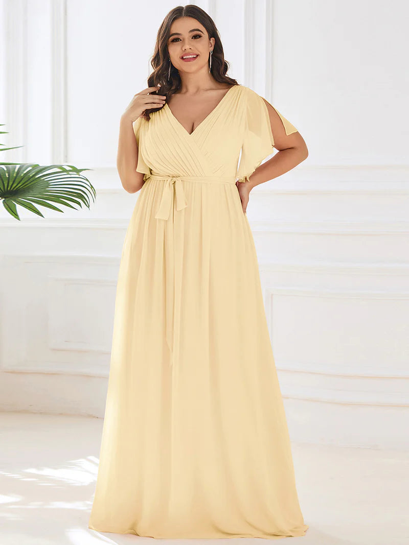Yellow plus sized bridesmaid dress with v-neck and a-line.