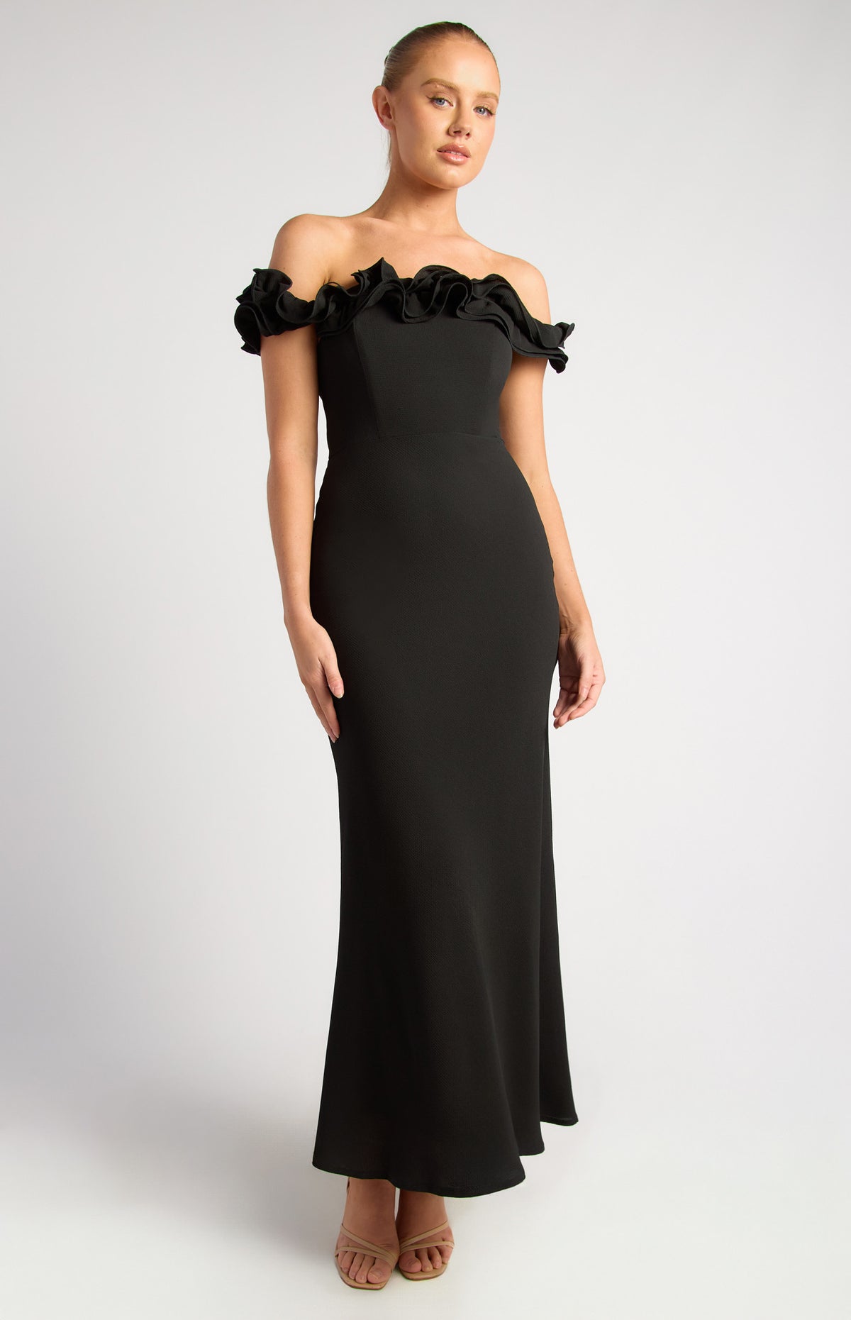 Black formal dress with ruffle neck and off shoulder sleeve.