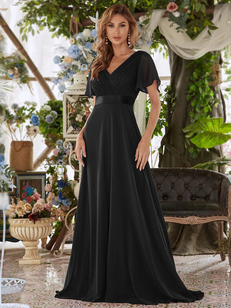 Black formal dress in chiffon with satin band and short sleeves.