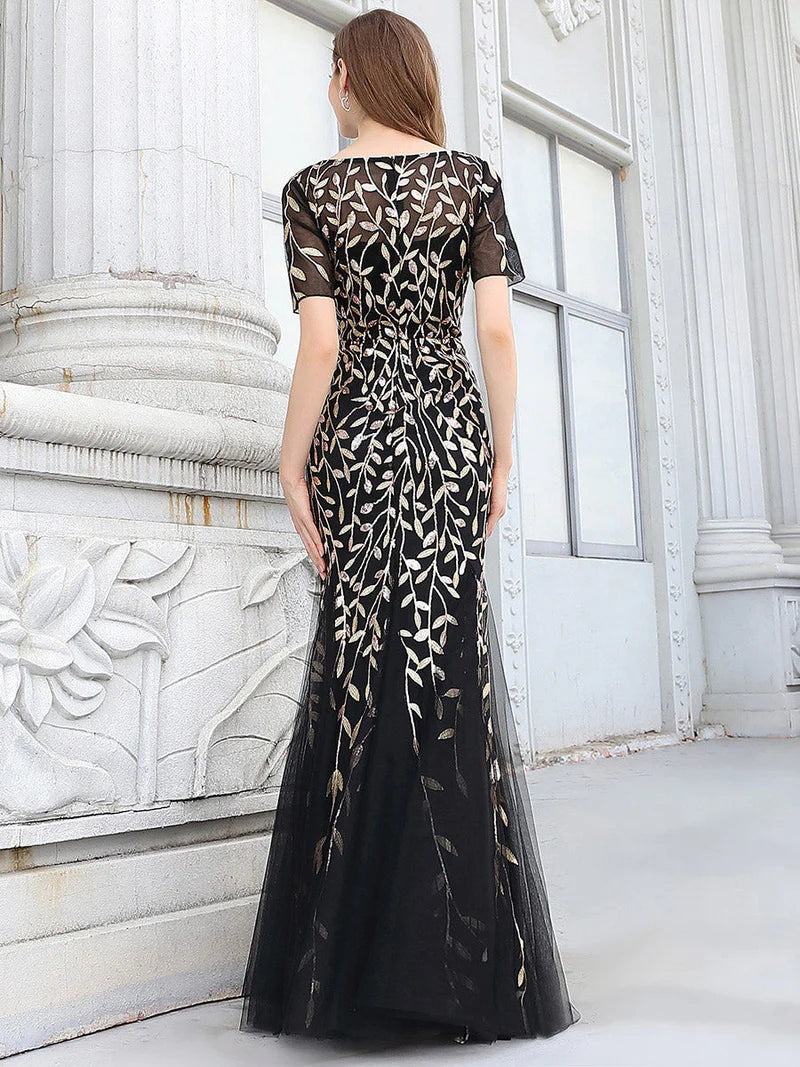 Black and gold Mother of the bride dress, short sleeve with tulle, lace and sequin detailing.