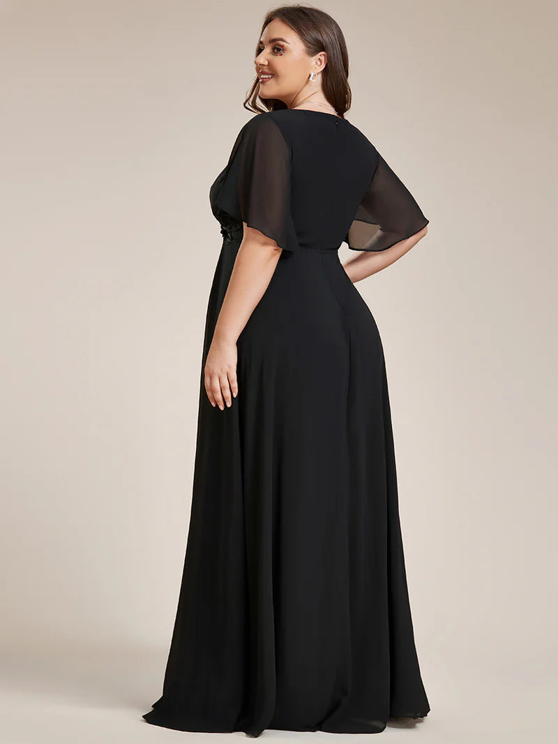 Black plus size formal dress with applique detail and short  sleeve.