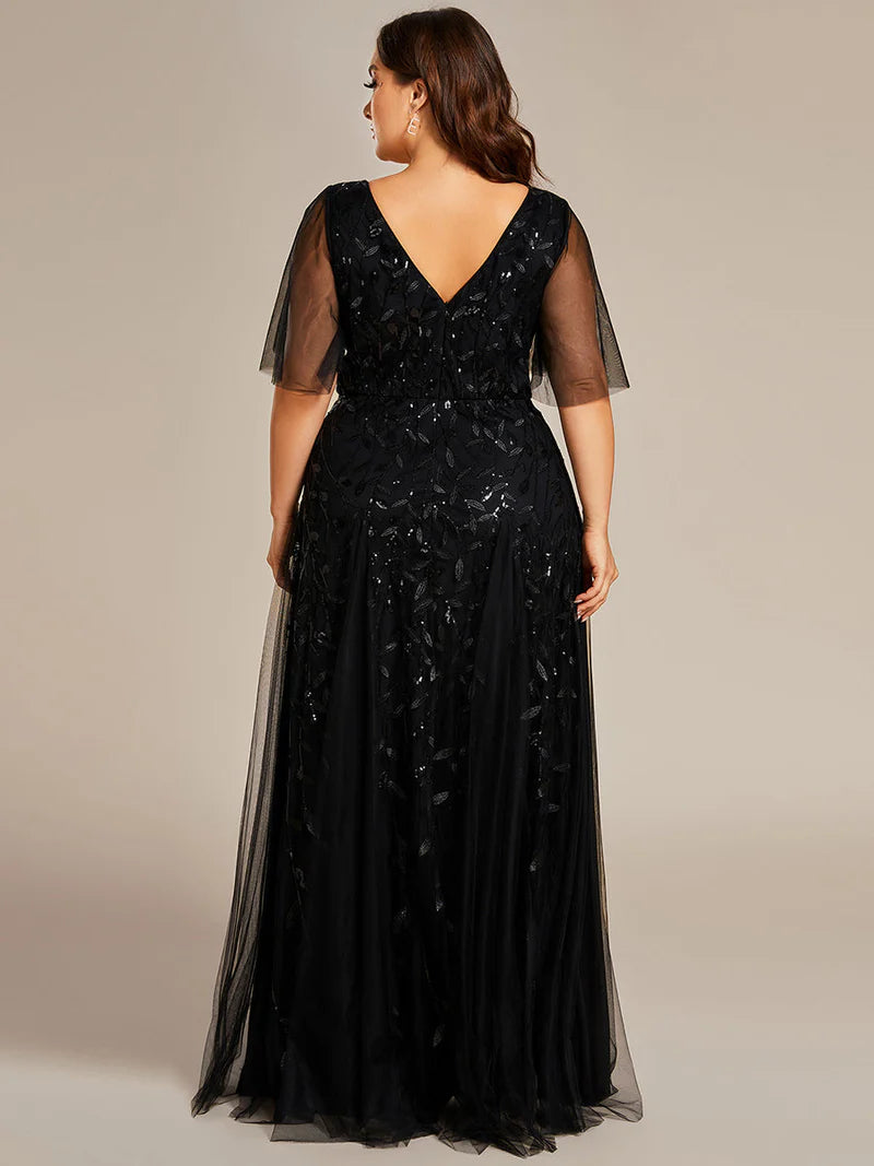 Black plus size mother of the bride dress with short sleeves and flowing tulle.