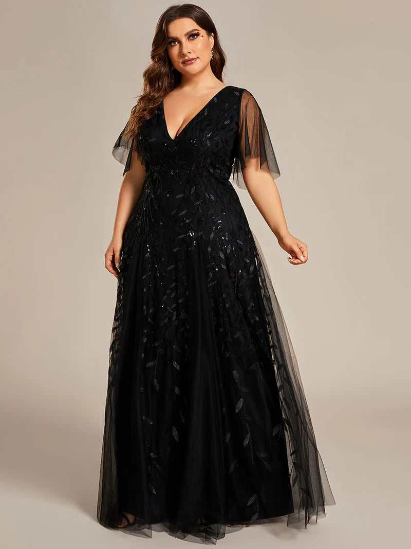 Black plus size mother of the bride dress with short sleeves and flowing tulle.