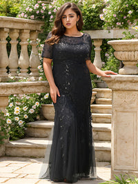 Black Plus Size Mother of the bride or formal dress, short sleeve with tulle, lace and sequin detailing.