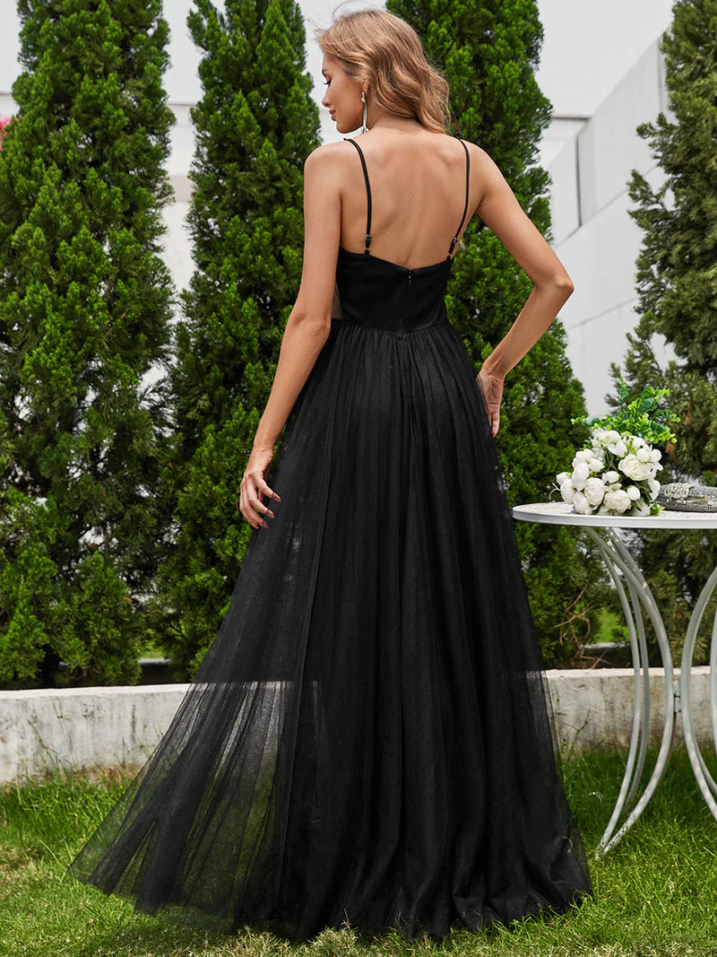 Black wedding dress with beaded bodice, tulle skirt and spaghetti straps.