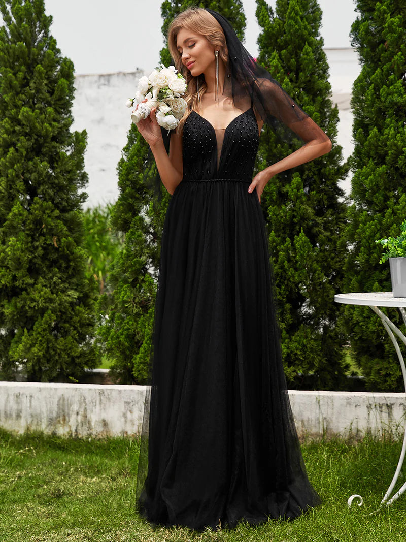 Black wedding dress with beaded bodice, tulle skirt and spaghetti straps.