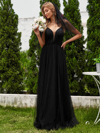 Black wedding dress with beaded bodice, tulle skirt and spaghetti straps.