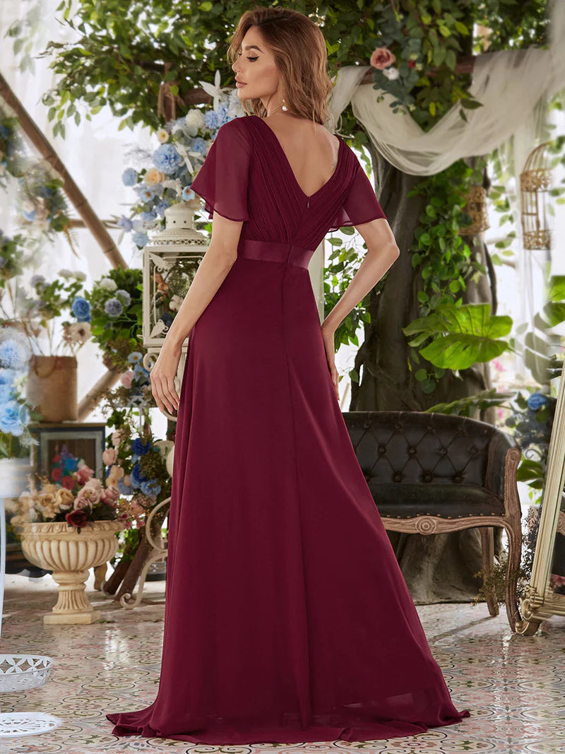 Burgundy formal dress in chiffon with satin band and short sleeves.