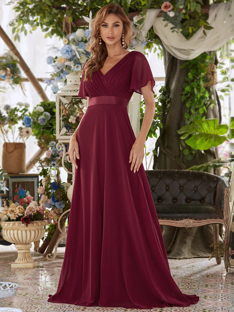 Burgundy formal dress in chiffon with satin band and short sleeves.