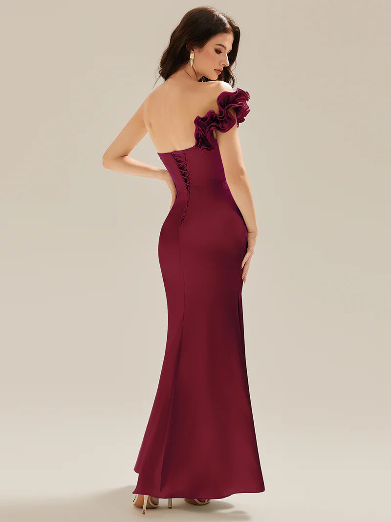 Burgundy strapless formal dress with fishtail and ruffles.