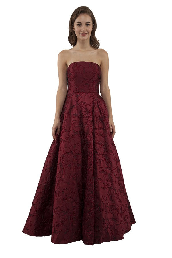 Burgundy strapless formal dress in brocade fabric.
