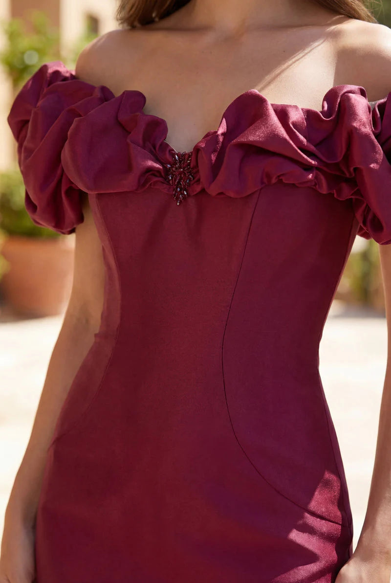 Burgundy off the shoulder ruffle sleeve formal dress with button detail on the back.