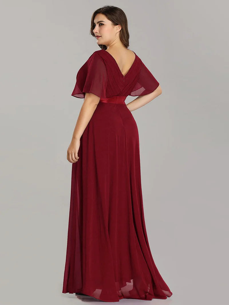 Burgundy plus size mother of the bride dress in chiffon with short sleeves and a satin band.