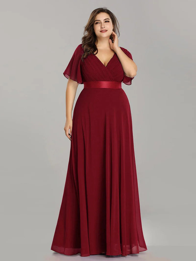 Burgundy plus size mother of the bride dress in chiffon with short sleeves and a satin band.